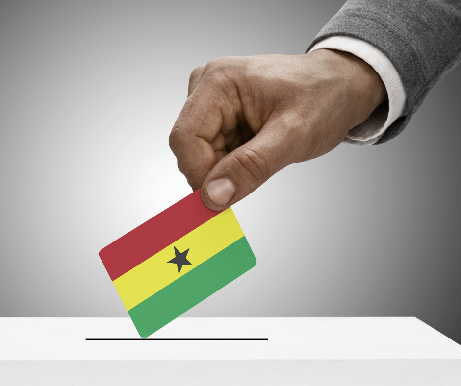 Hand holding ghana flag colors vote at ballot box